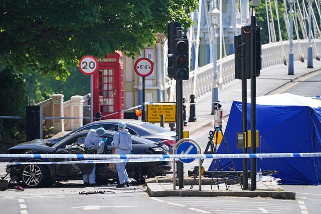 <p>Police forensic officers at the scene at Cheyne Walk in Chelsea, London, after a 41-year-old woman and three dogs have been killed following a car crash. </p>