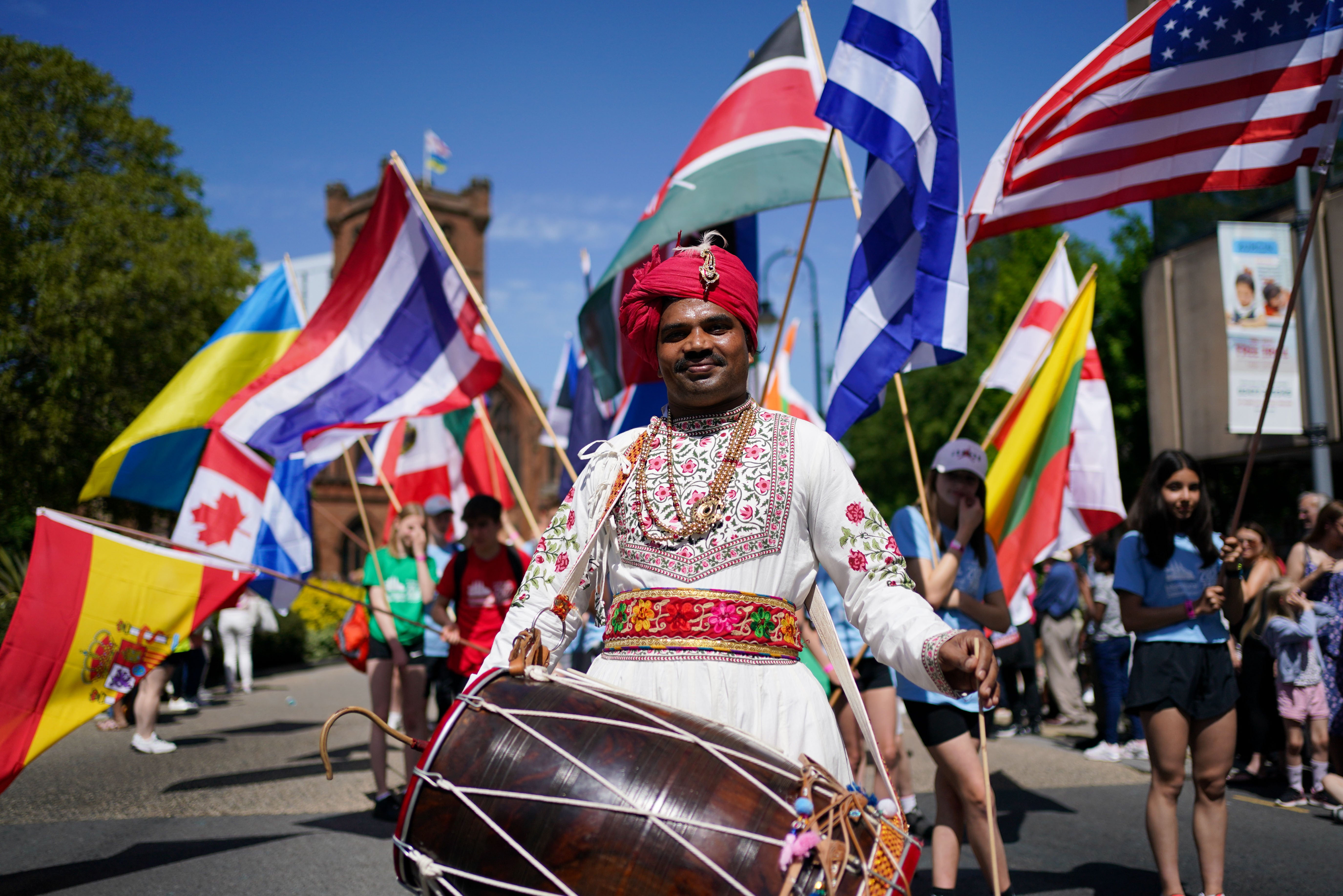 Performers take part in a ‘This is the City’ carnival through the streets of Coventry (PA)