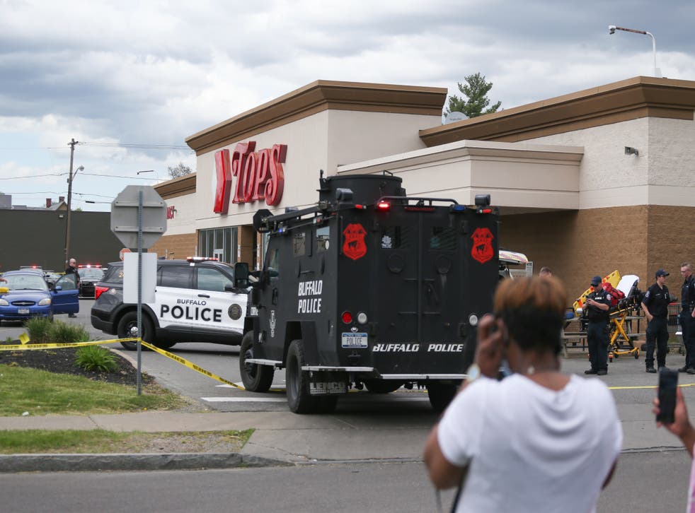<p>A crowd gathers as police investigate after a shooting at a supermarket on Saturday, May 14, 2022, in Buffalo, N.Y. Multiple people were shot  at the Tops Friendly Market</p>