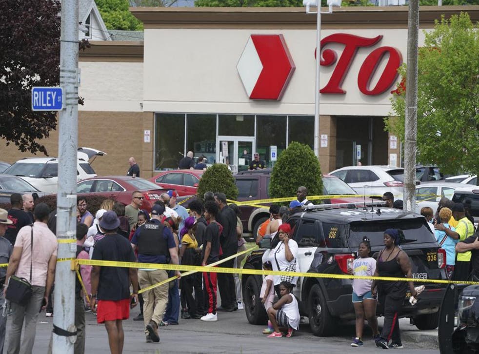 <p>People gather outside a supermarket where several people were killed in a shooting, Saturday in Buffalo </p>