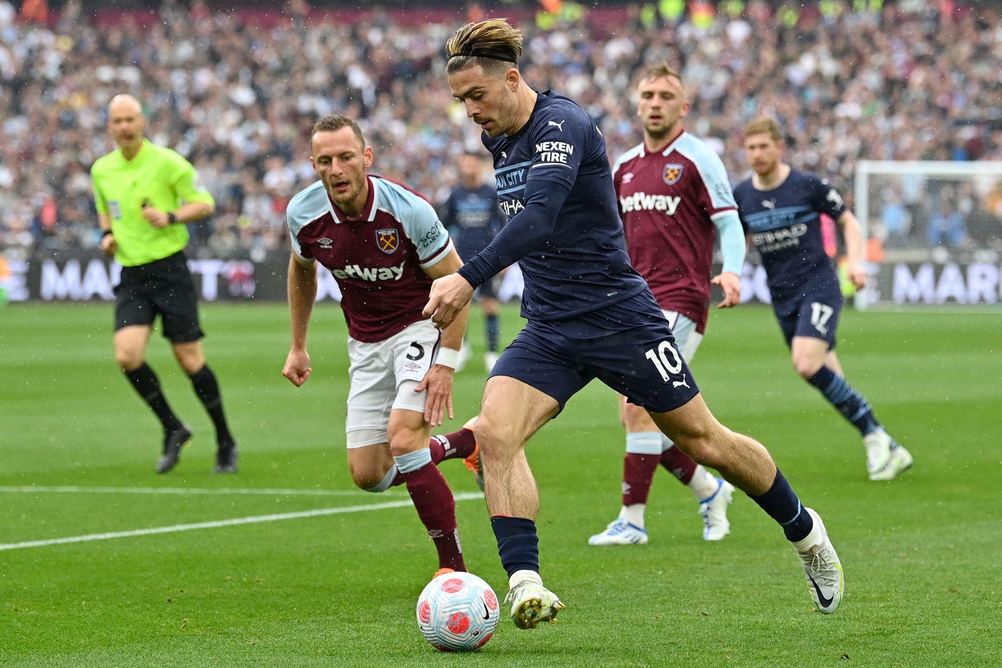 Jack Grealish dribbles the ball to the byline