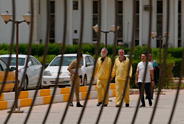 <p>Jim Fitton on the left and Volker Waldmann on the right, both wearing yellow suits </p>