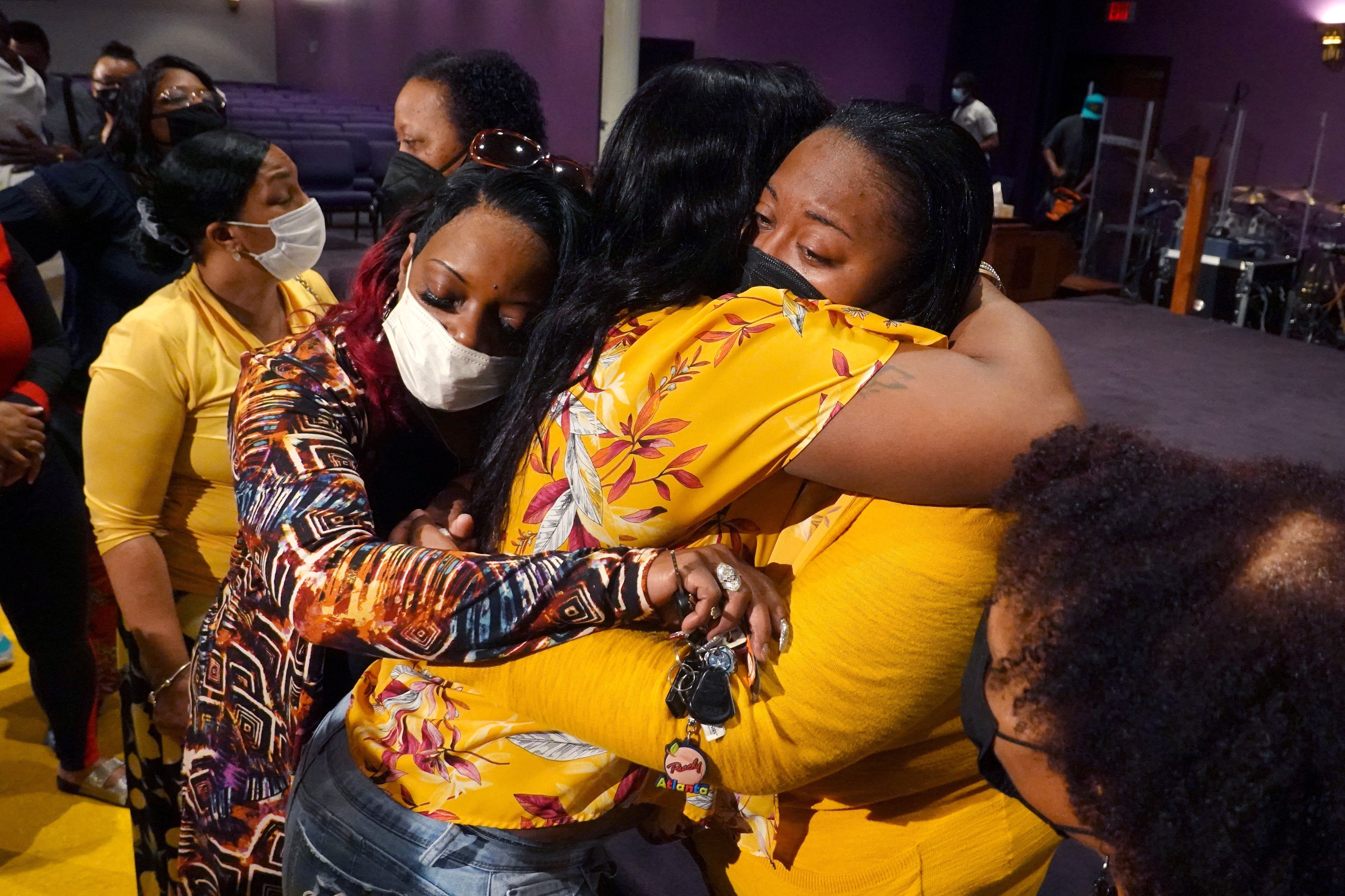 Latisha (R), a clerk at Tops market, who called 911 when when a gunman opened fire at the store, is consoled during services at True Bethel Baptist Churc
