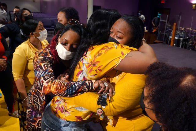 <p>Latisha (right), a clerk at Tops market who called 911 when when a gunman opened fire at the store, is consoled during services at True Bethel Baptist Church </p>