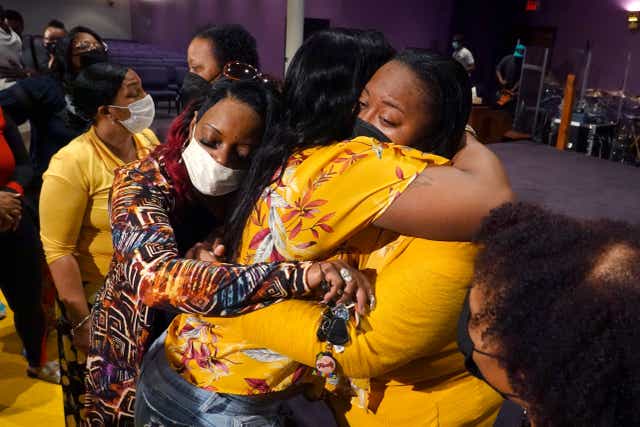 <p>Latisha (right), a clerk at Tops market who called 911 when when a gunman opened fire at the store, is consoled during services at True Bethel Baptist Church </p>