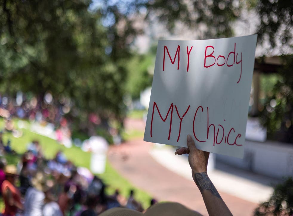 <p>Debbie Jeffreys of Metairie, Louisiana, holds a sign during nationwide demonstrations supporting abortion rights on 14 May. </p>