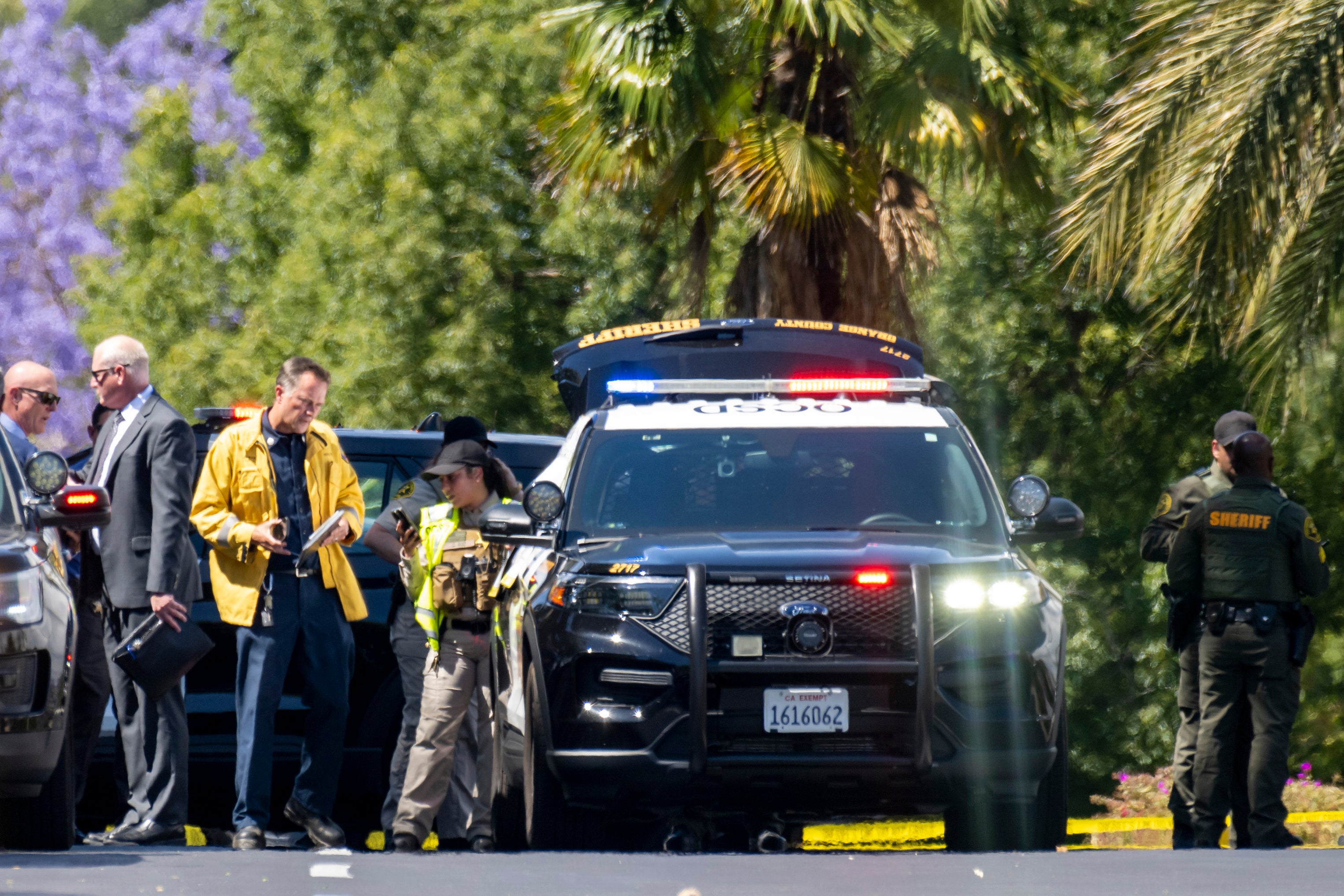 Investigators gather outside the Geneva Presbyterian Church in Laguna Woods, California on Sunday