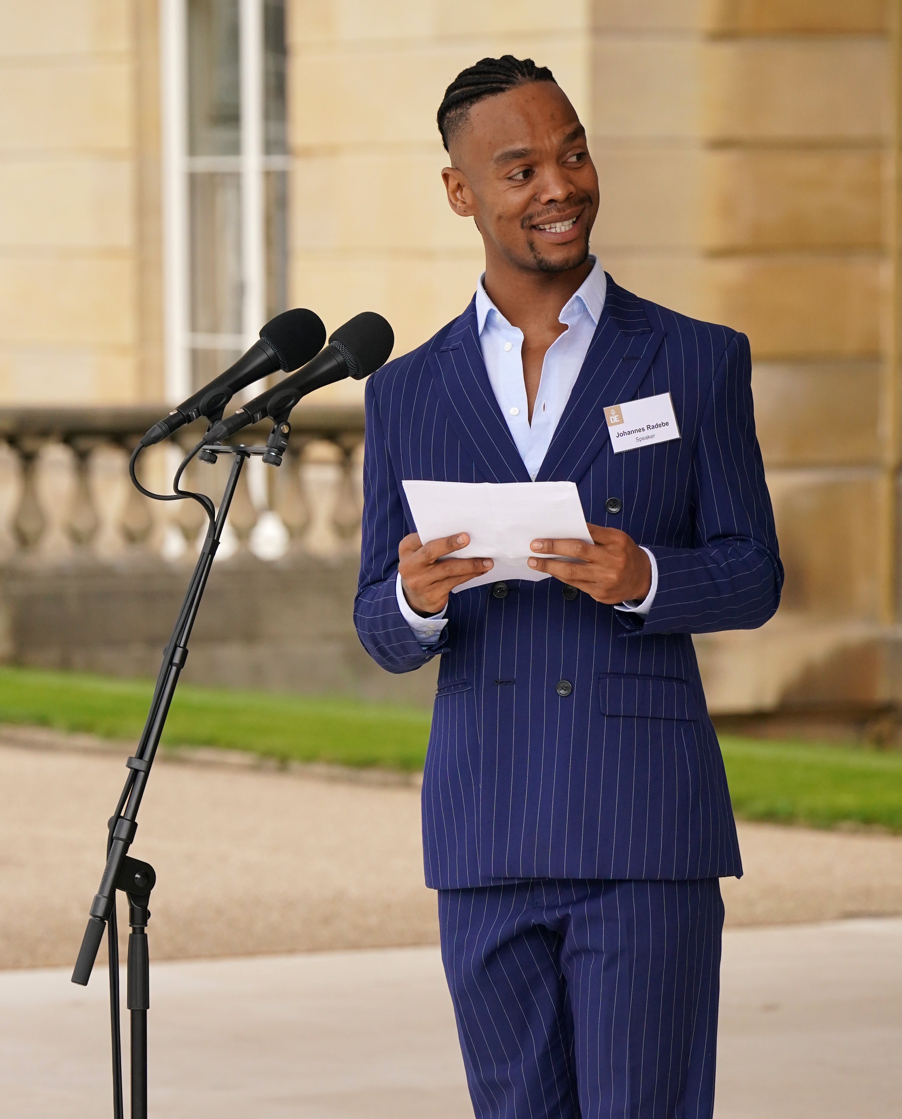 Johannes Radebe makes a speech on the steps of Buckingham Palace during the Duke of Edinburgh Gold Award presentations (Jonathan Brady/PA)
