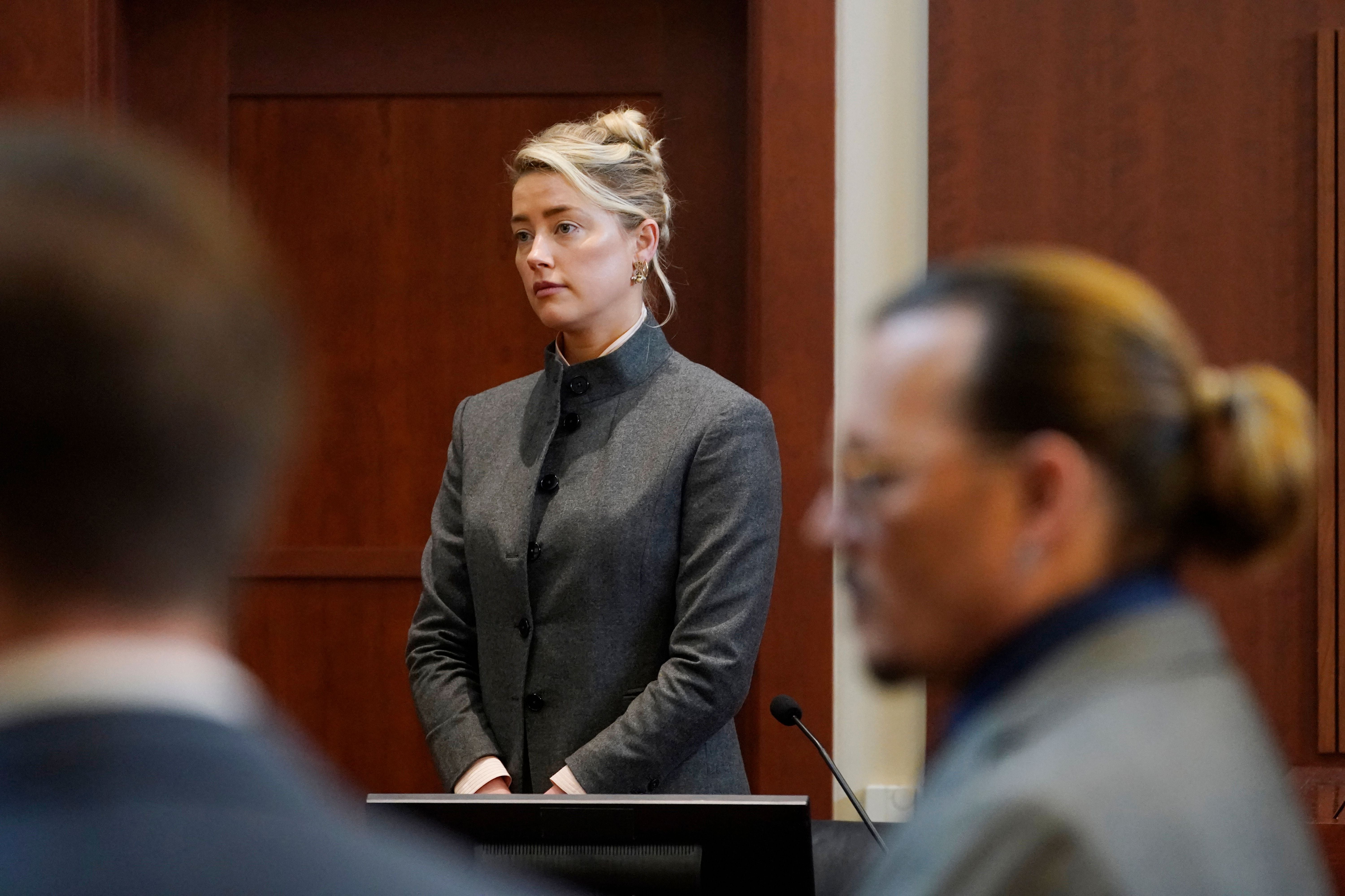 Amber Heard and Johnny Depp watch as the jury comes into the courtroom at the Fairfax County Courthouse in Fairfax, Virginia, on 16 May 2022