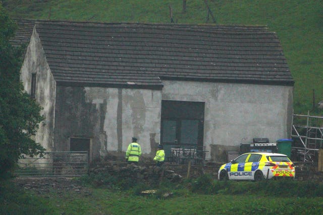 <p>Police at a building in Milnrow, Rochdale after a three-year-old boy died after a suspected dog attack</p>