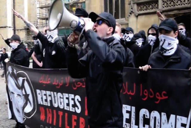 <p>Alex Davies speaking at a 2016 National Action demonstration in York, in front of a banner containing the words ‘Refugees not welcome: Hitler was right.’  </p>