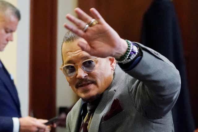 <p>Johnny Depp waves to the courtroom gallery at the end of the day’s proceedings at the Fairfax County Circuit Courthouse in Fairfax, Virginia</p>