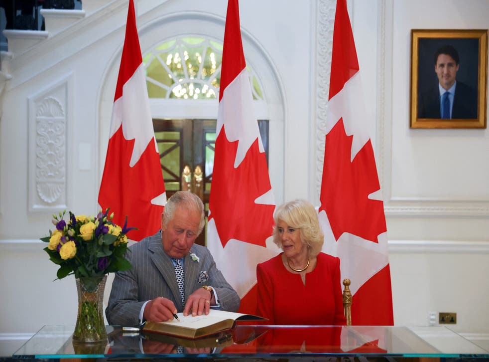 The Prince of Wales and Duchess of Cornwall sign a guest book during their visit to Canada House in London, ahead of the forthcoming tour (Hannah McKay/PA)