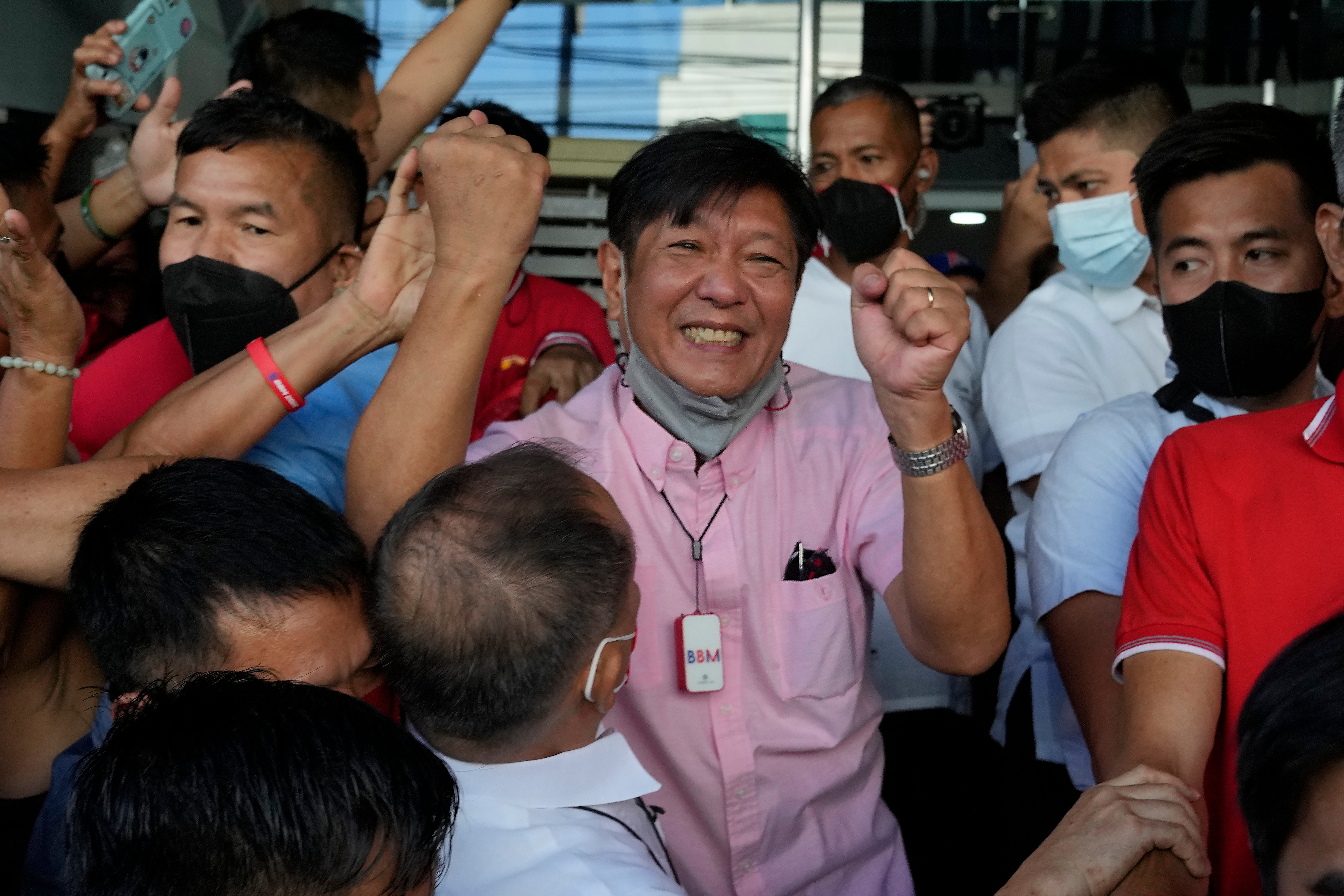 <p>Ferdinand ‘Bongbong’ Marcos Jr celebrates outside his headquarters in Mandaluyong, Philippines on 11 May</p>