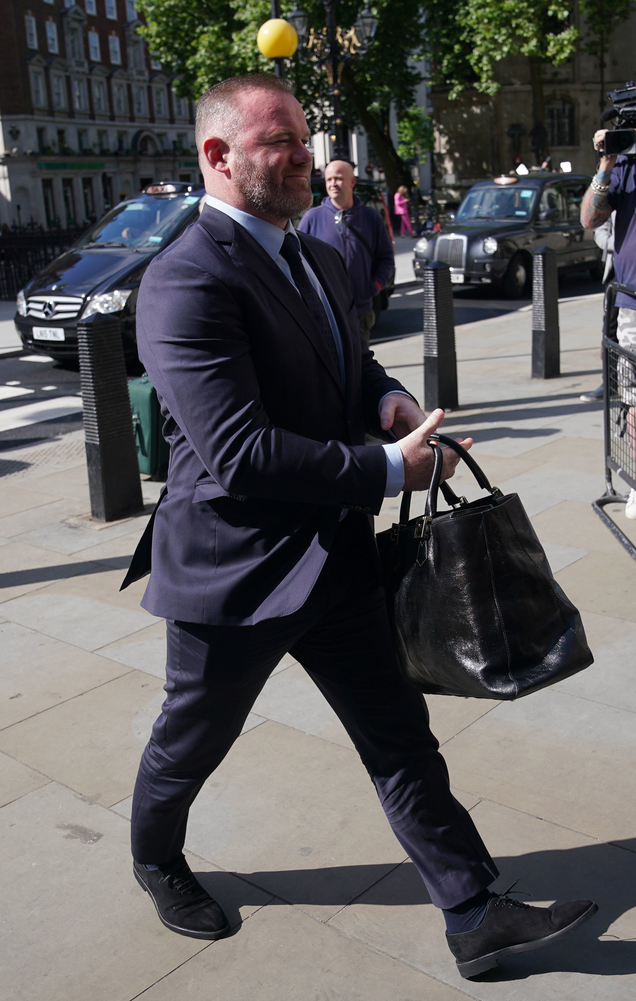 Wayne Rooney wears a blue suit on day six of the libel trial