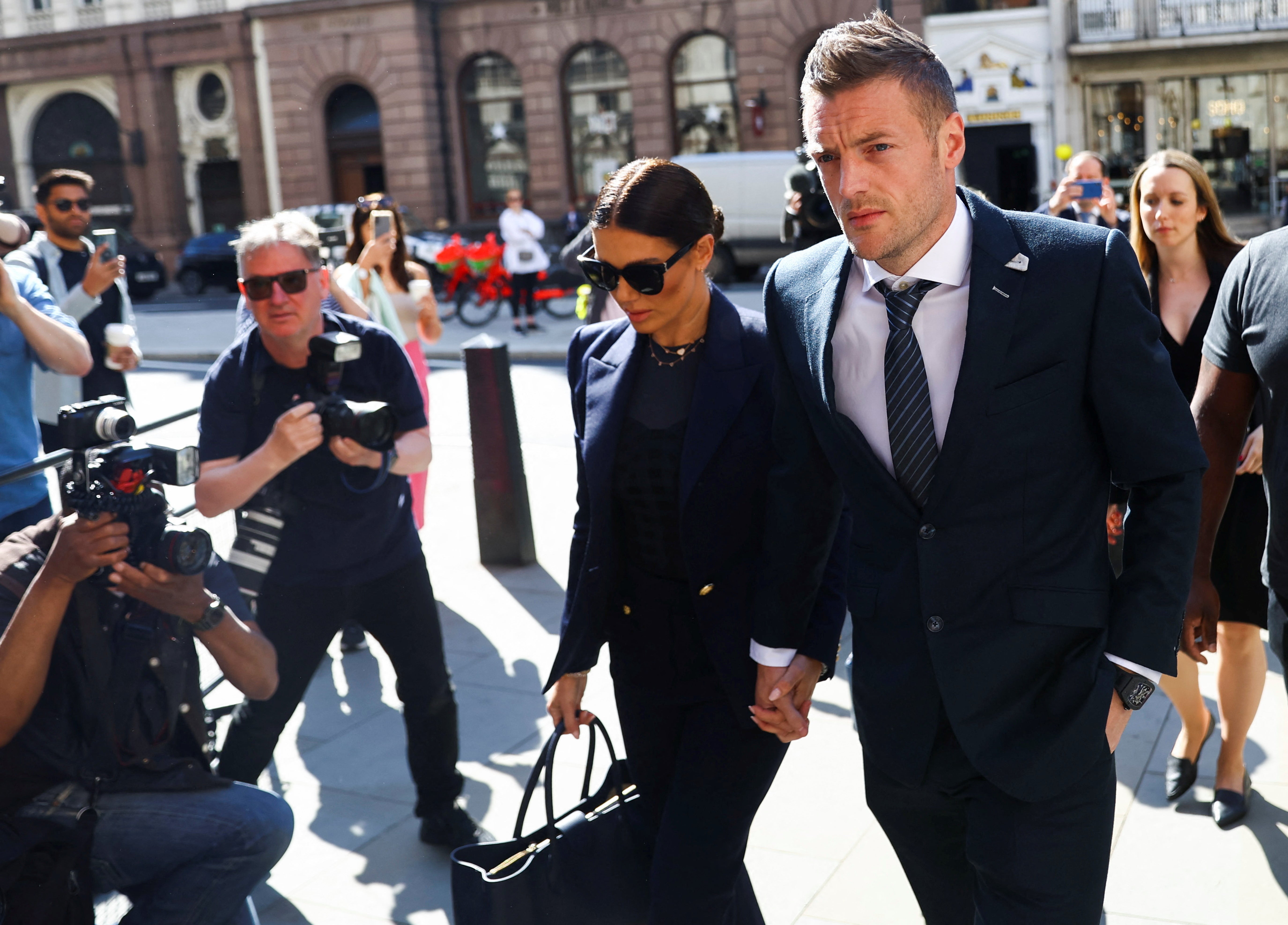 Jamie and Rebekah Vardy hold hands as they arrive at the High Court