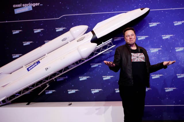 <p>SpaceX owner and Tesla CEO Elon Musk stands in front of a model rocket</p>