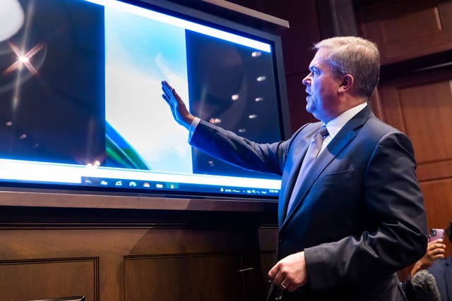 <p>Deputy Director of Naval Intelligence Scott Bray plays a video of an 'unidentified aerial phenomena', commonly referred to as UFOs, during a hearing before a subcommittee of the House Intelligence Committee on the phenomena in the US Capitol in Washington, DC, USA, 17 May 2022. It is the first public hearing on UFOs on Capitol Hill since the 1960s.  EPA/JIM LO SCALZO</p>