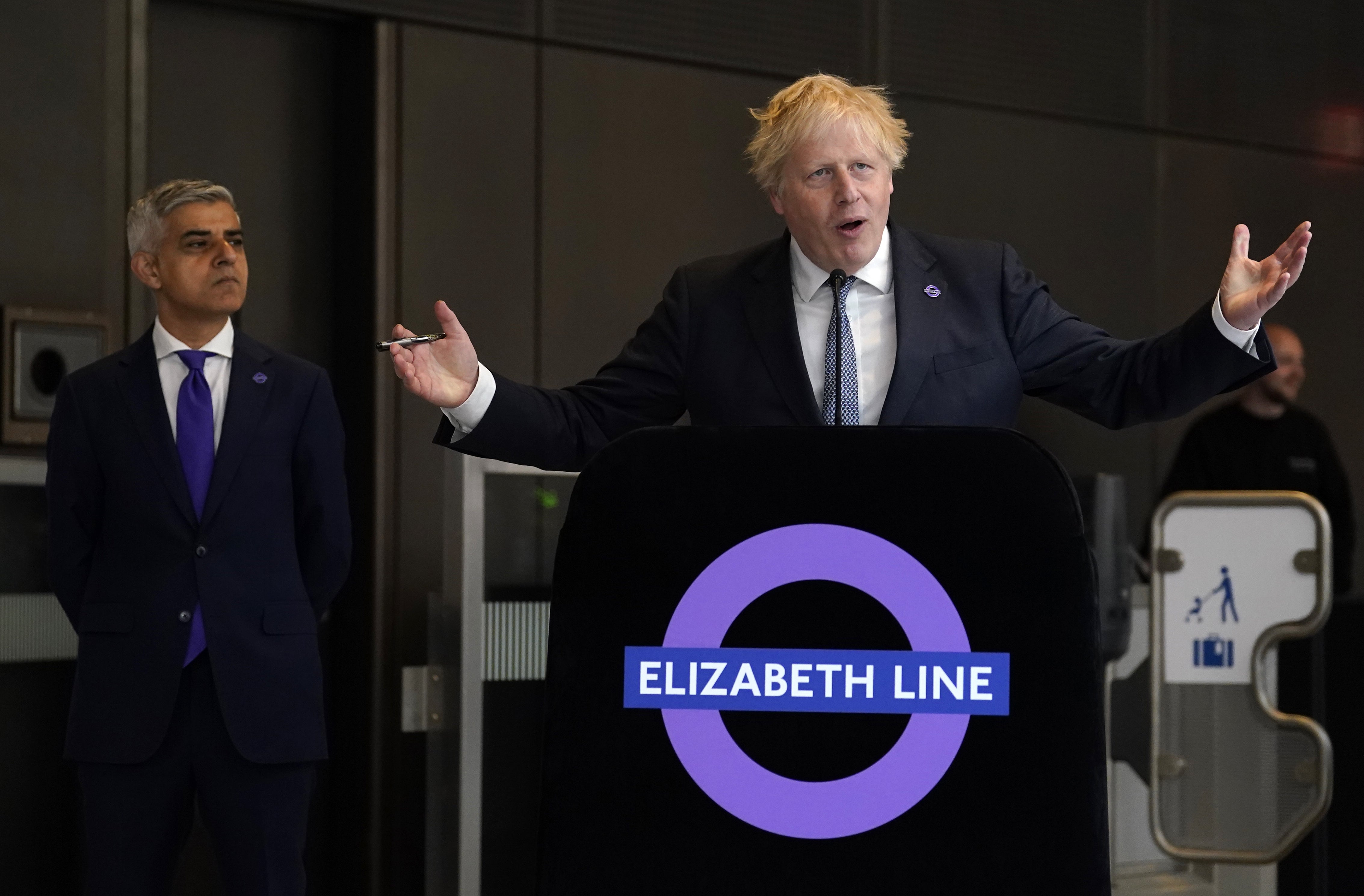 Mayor of London Sadiq Khan looks on as Boris Johnson speaks at the completion of the Elizabeth line in 2022 (Andrew Matthews/PA)