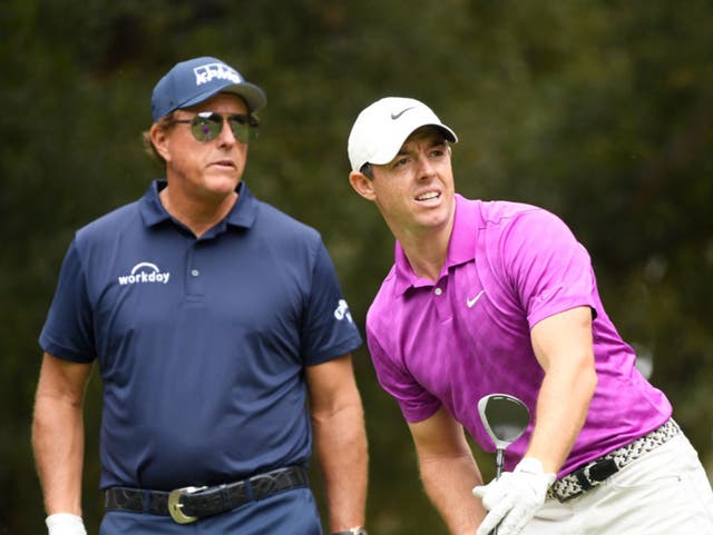 <p>Rory McIlroy and Phil Mickelson play alongside each other in 2020</p>