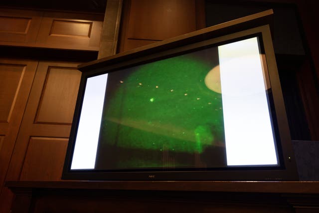 <p>An ‘unidentified aerial phenomena’, commonly referred to as a UFO, is shown on a TV monitor during a House hearing </p>