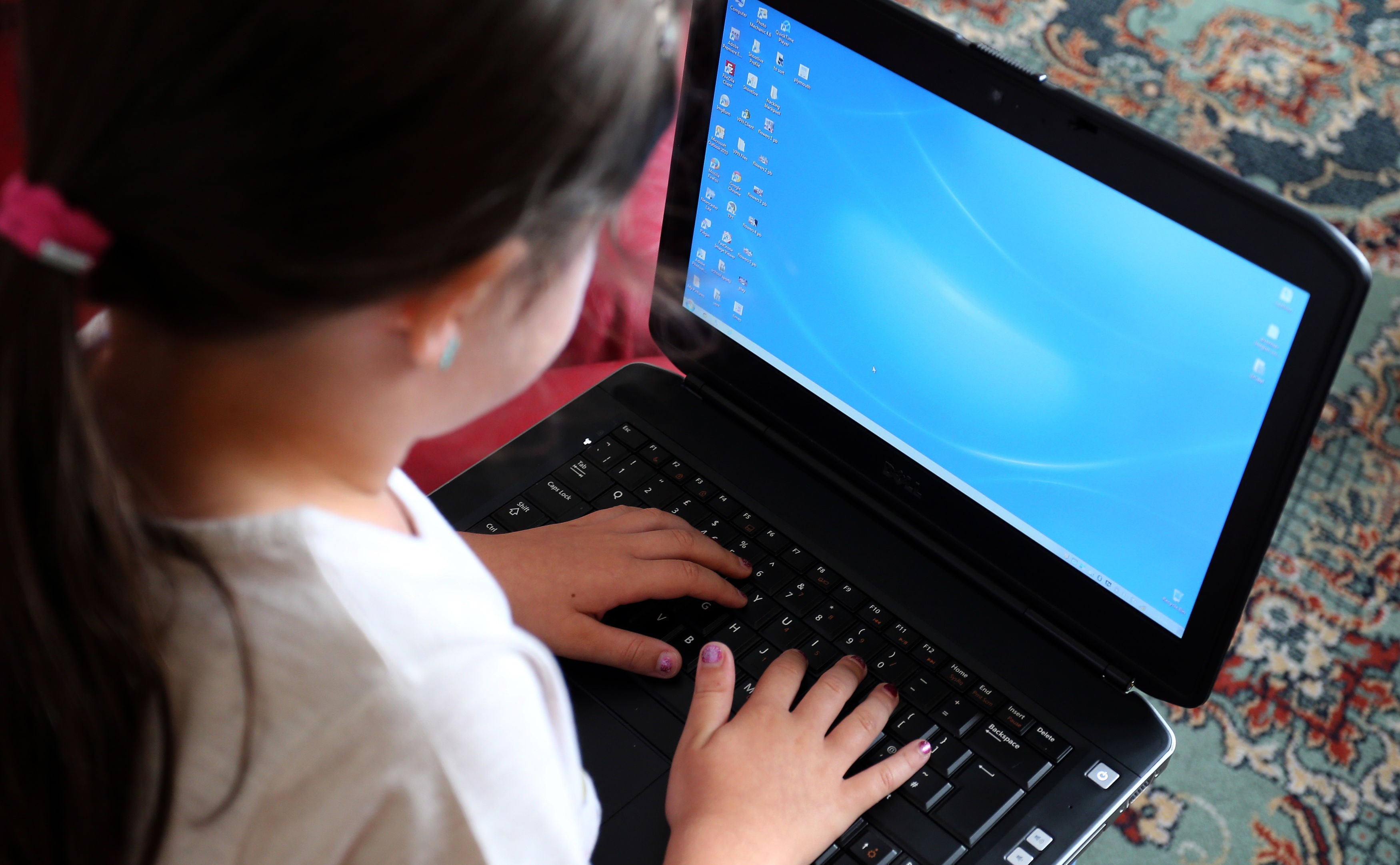 A child using a laptop computer, as some pupils have begun the new school term learning remotely as the Omicron variant causes disruption across the country (PA)