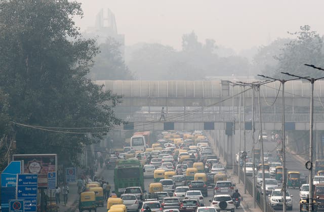 <p>File photo: A pedestrian walks on a bridge above vehicle traffic in New Delhi, India on 12 November 2019 as the city is enveloped under thick smog</p>