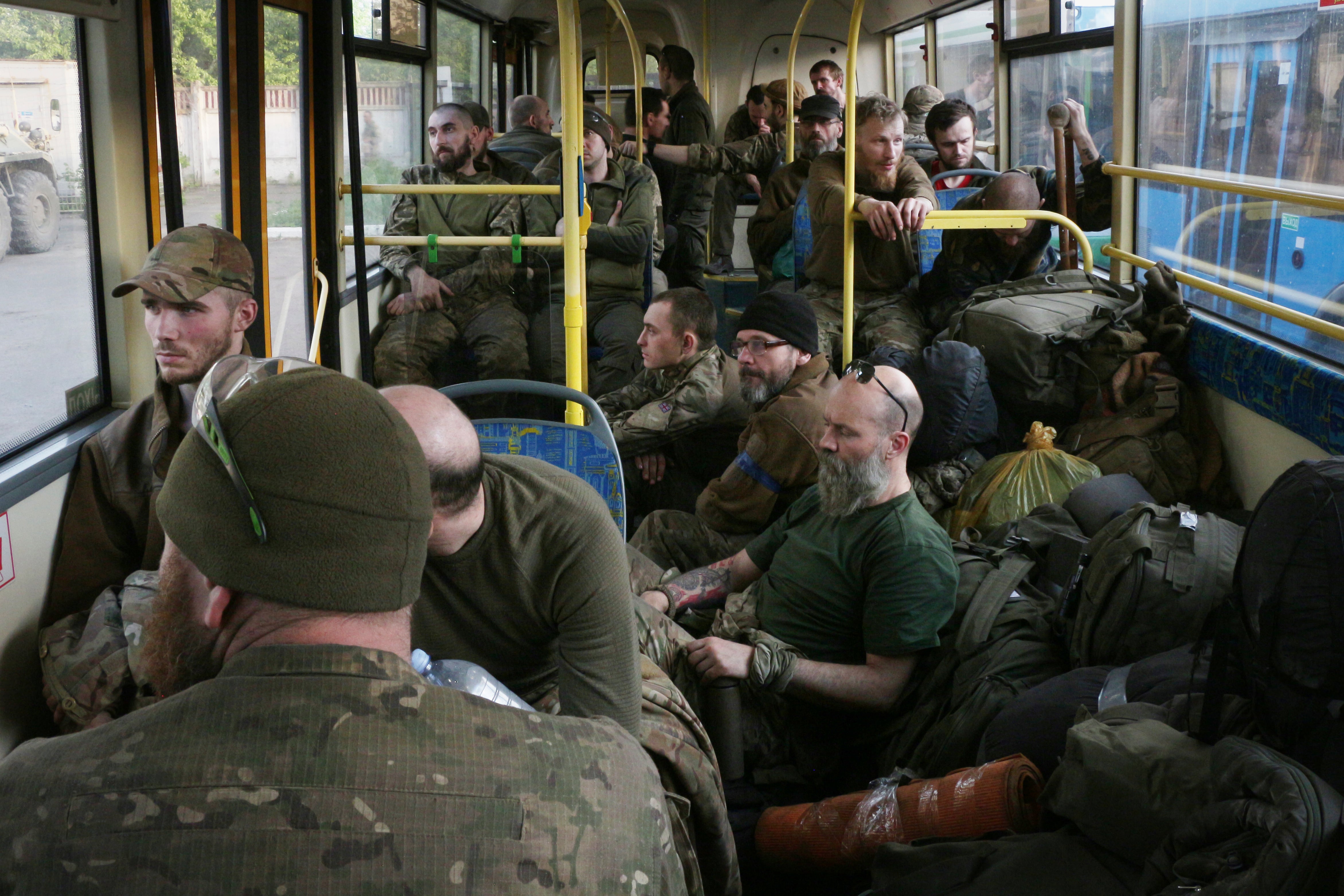 Ukrainian servicemen sit in a bus after they were evacuated from the besieged Mariupol's Azovstal steel plant