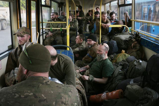 <p>Ukrainian servicemen sit in a bus after they were evacuated from the besieged Mariupol's Azovstal steel plant</p>