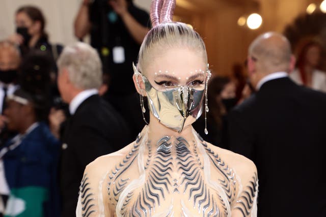 <p>Grimes wore the metal face mask and elf ears at the Met Gala 2021</p>