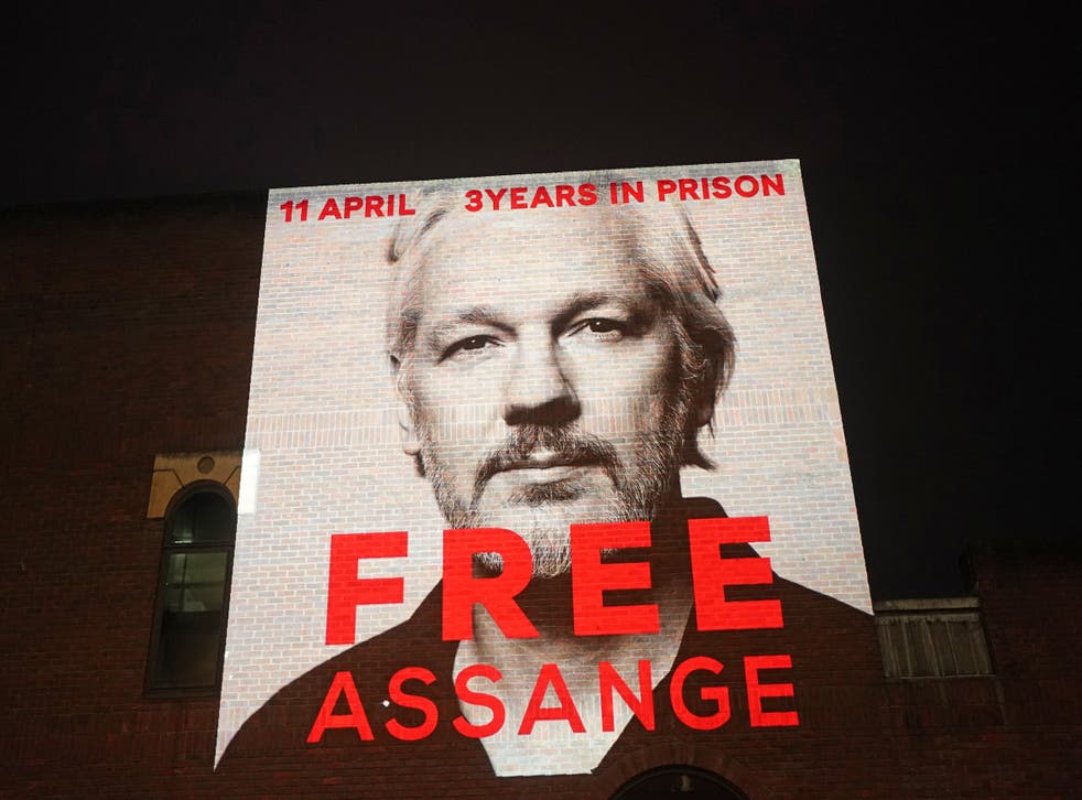 An image of Julian Assange projected onto a building near St Paul’s cathedral in central London earlier this year (Victoria Jones/PA)