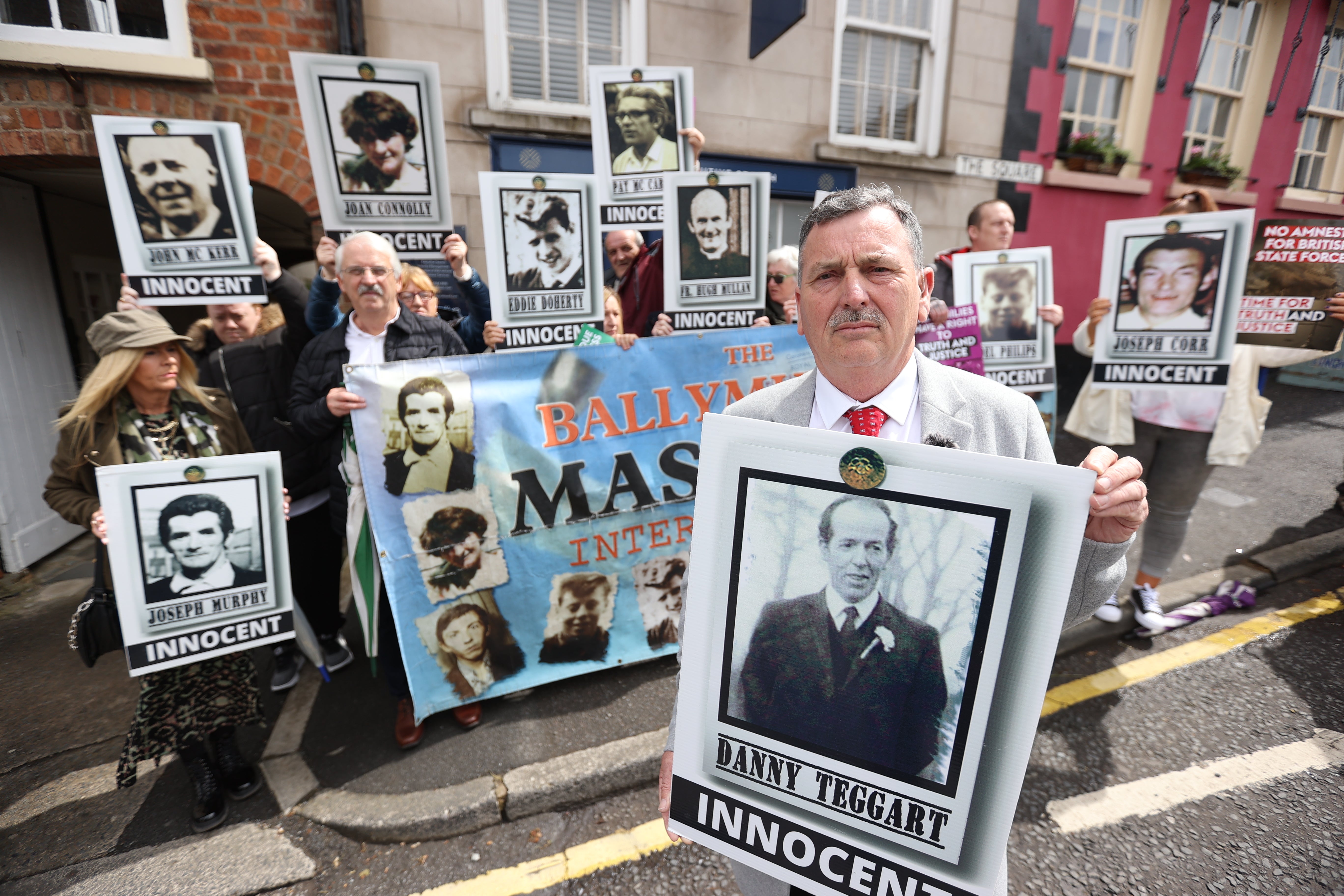 John Teggart, son of victim Daniel Teggart demonstrating with some of the families of the 11 people killed by soldiers in Ballymurphy in west Belfast in 1971 (Liam McBurney/PA)