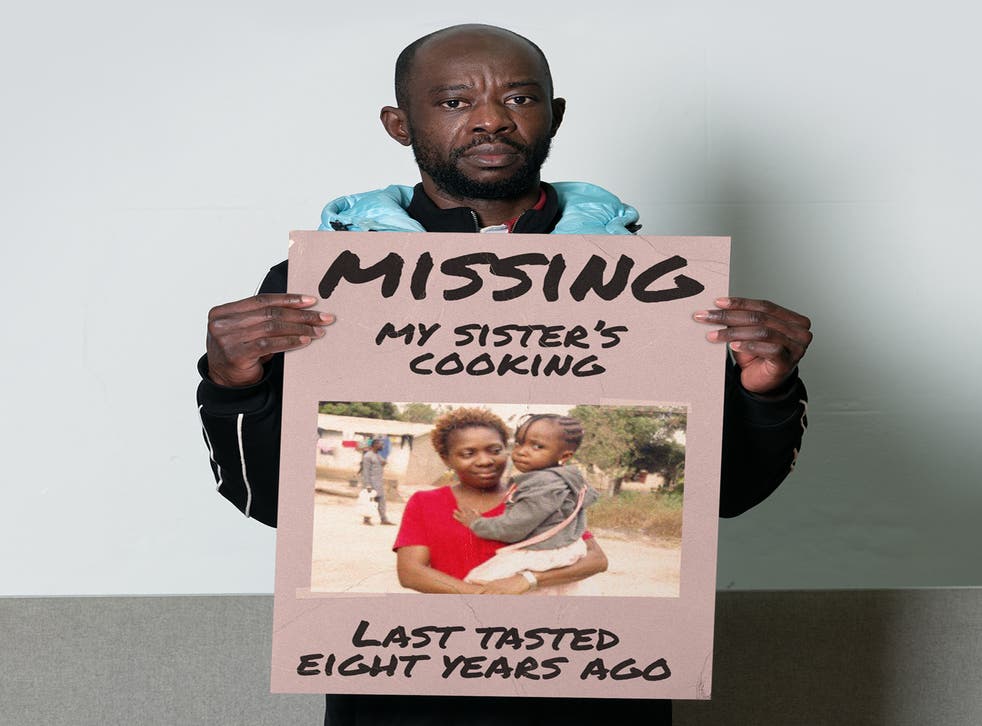 Siki pictured holding a missing poster, with a picture of his sister and her daughter on it (Inzajeano Latif and Migrant Help/PA)