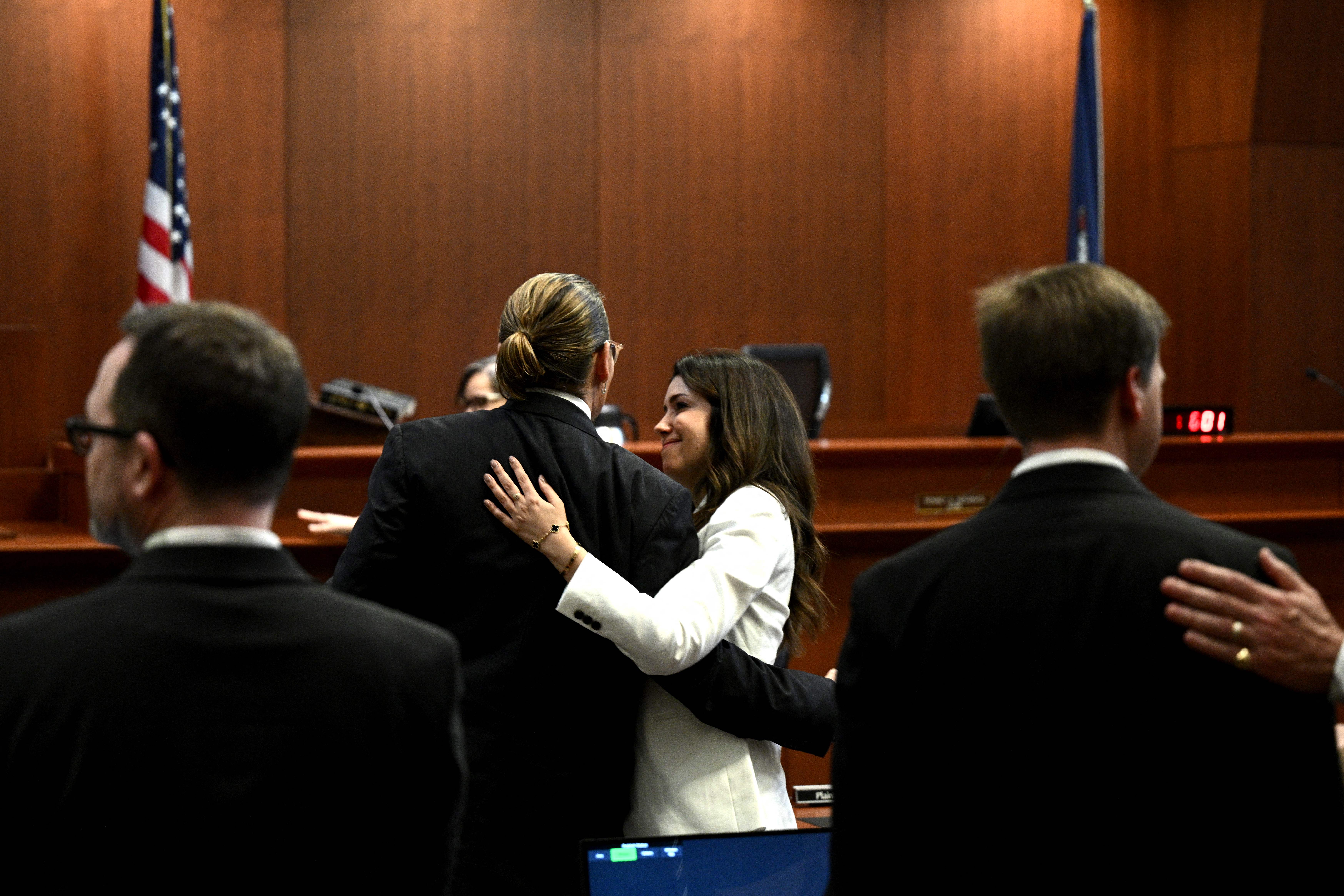 Attorney Camille Vasquez embraces US actor Johnny Depp in the courtroom at the Fairfax County Circuit Courthouse in Fairfax, Virginia, on May 17, 2022.