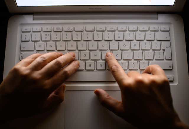 Generic stock photo shows a woman’s hands using a laptop keyboard (Dominic Lipinski/PA)