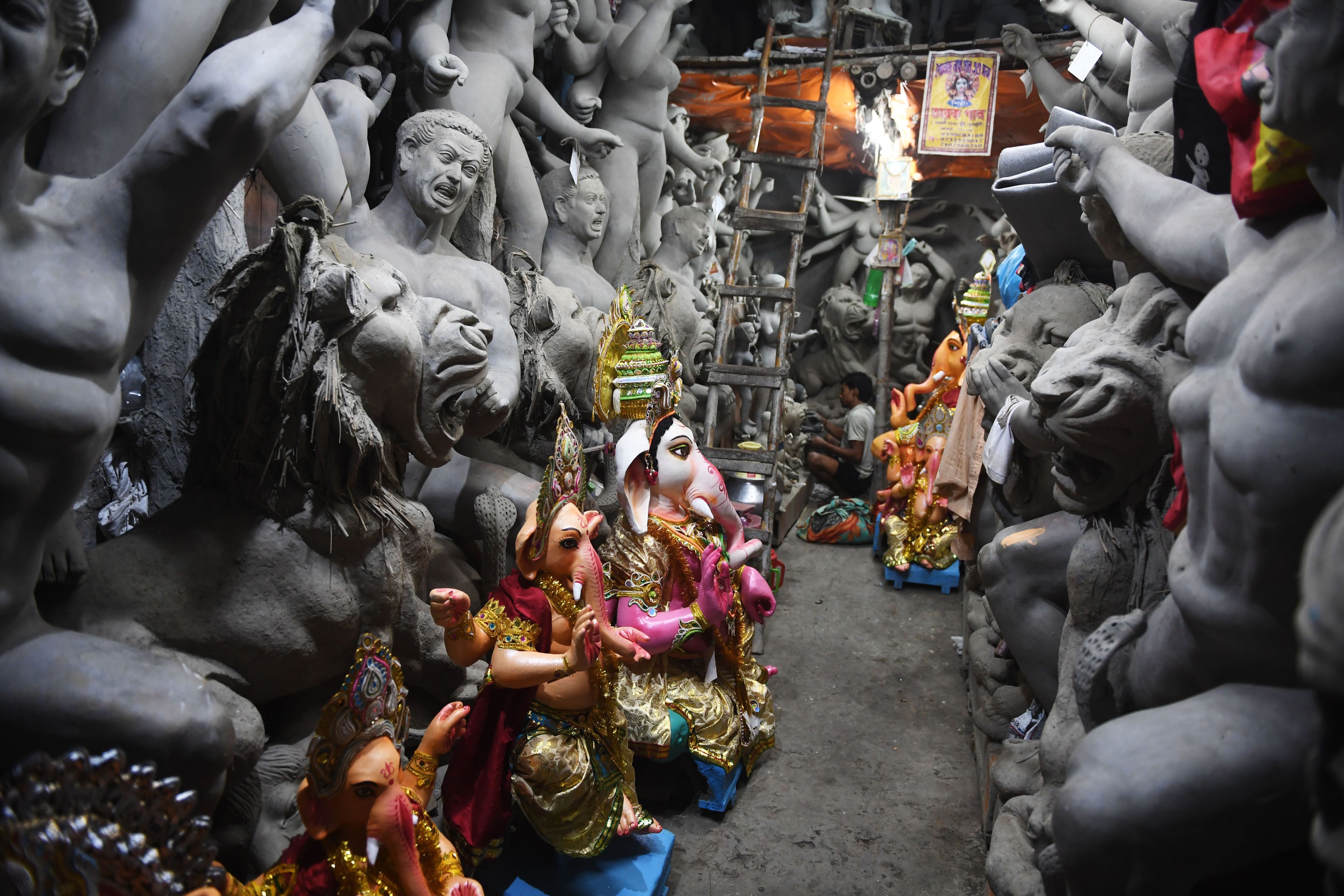 Representative: An artisan works on an idol of Hindu deity inside a workshop in India