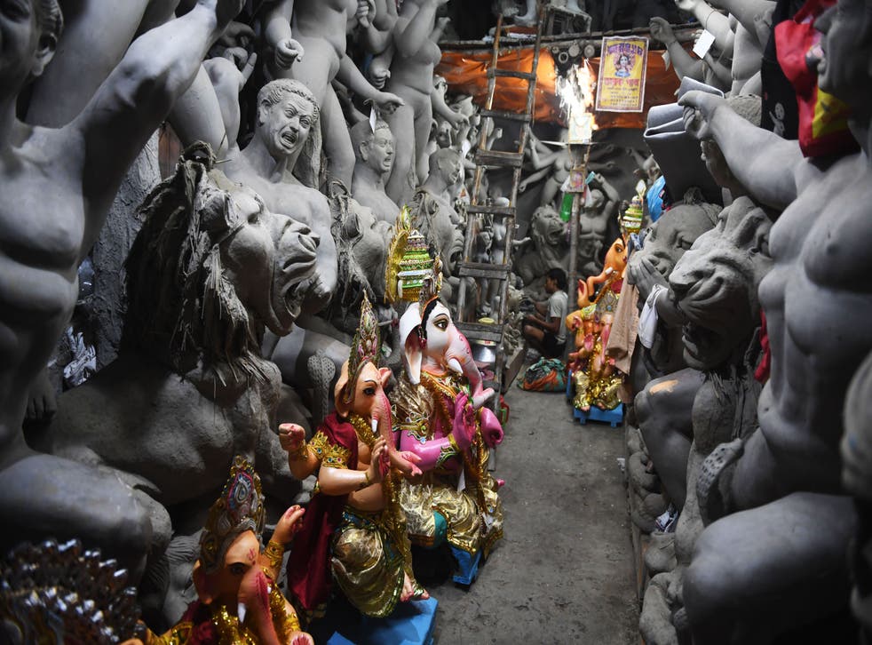 <p>Representative: An artisan works on an idol of Hindu deity inside a workshop in India</p>