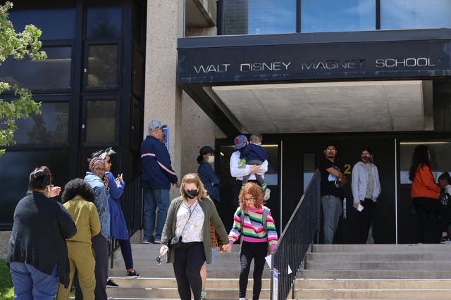 <p>Parents wait to pick up their children at Walt Disney Magnet School in Chicago on Tuesday</p>