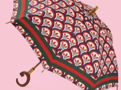 The green and red sun umbrella is a part of a joint Adidas x Gucci collection