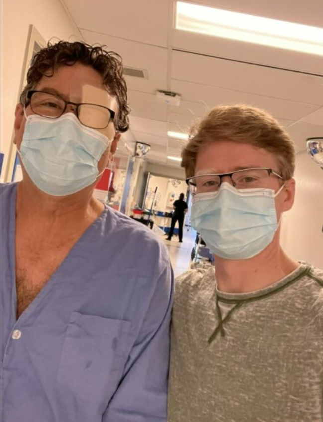 Ed Steinkamp, left, and his son, Bret Steinkamp, right, pose in the hospital together after the terrifying ordeal that saw the 67-year-old lose the use of his eye.