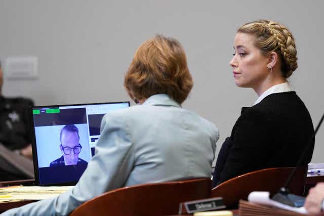 <p>Amber Heard listens to testimony from Johnny Depp’s attorney Adam Waldman</p>