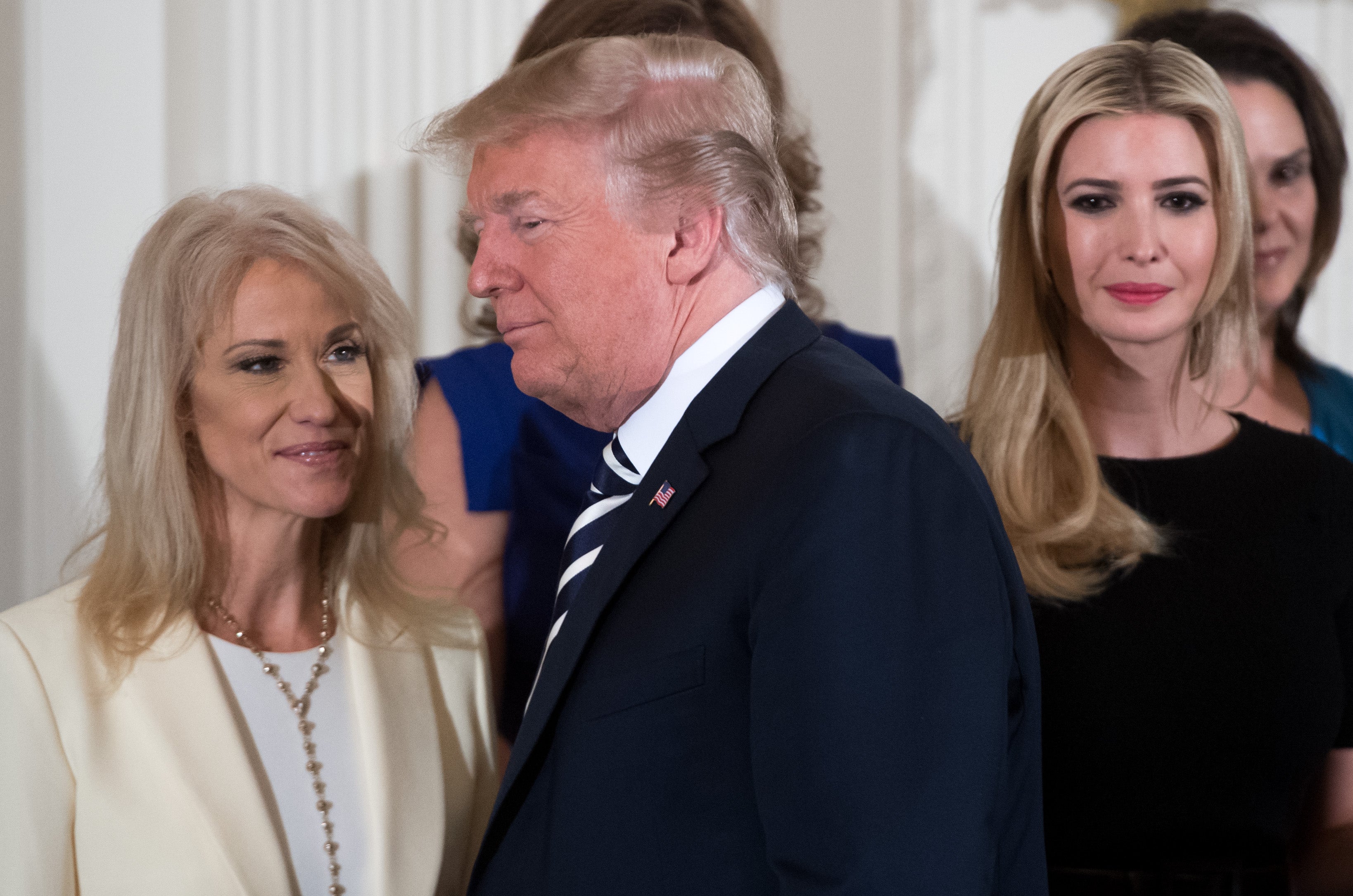US President Donald Trump walks past his daughter Ivanka Trump (R) and Kellyanne Conway (L), White House Counselor, during an event in honor of Military Mothers and Spousesin May 2018