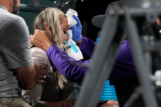 <p>Colorado Rockies television reporter Kelsey Wingert is attended to after being hit by a foul ball off the bat of San Francisco Giants' Austin Slater in the ninth inning of a baseball game Monday, May 16, 2022, in Denver.</p>