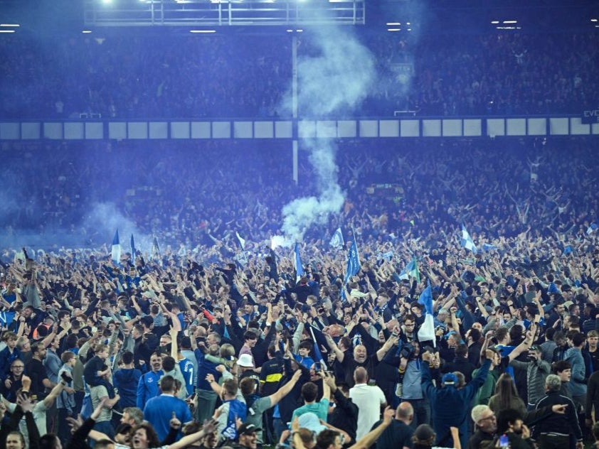 Everton fans celebrate on the pitch at Goodison Park