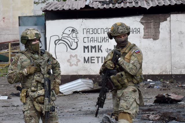 <p>Russian soldiers guard part of the Ilyich Iron and Steel Works in Mariupol, Ukraine, on 18 May, 2022</p>