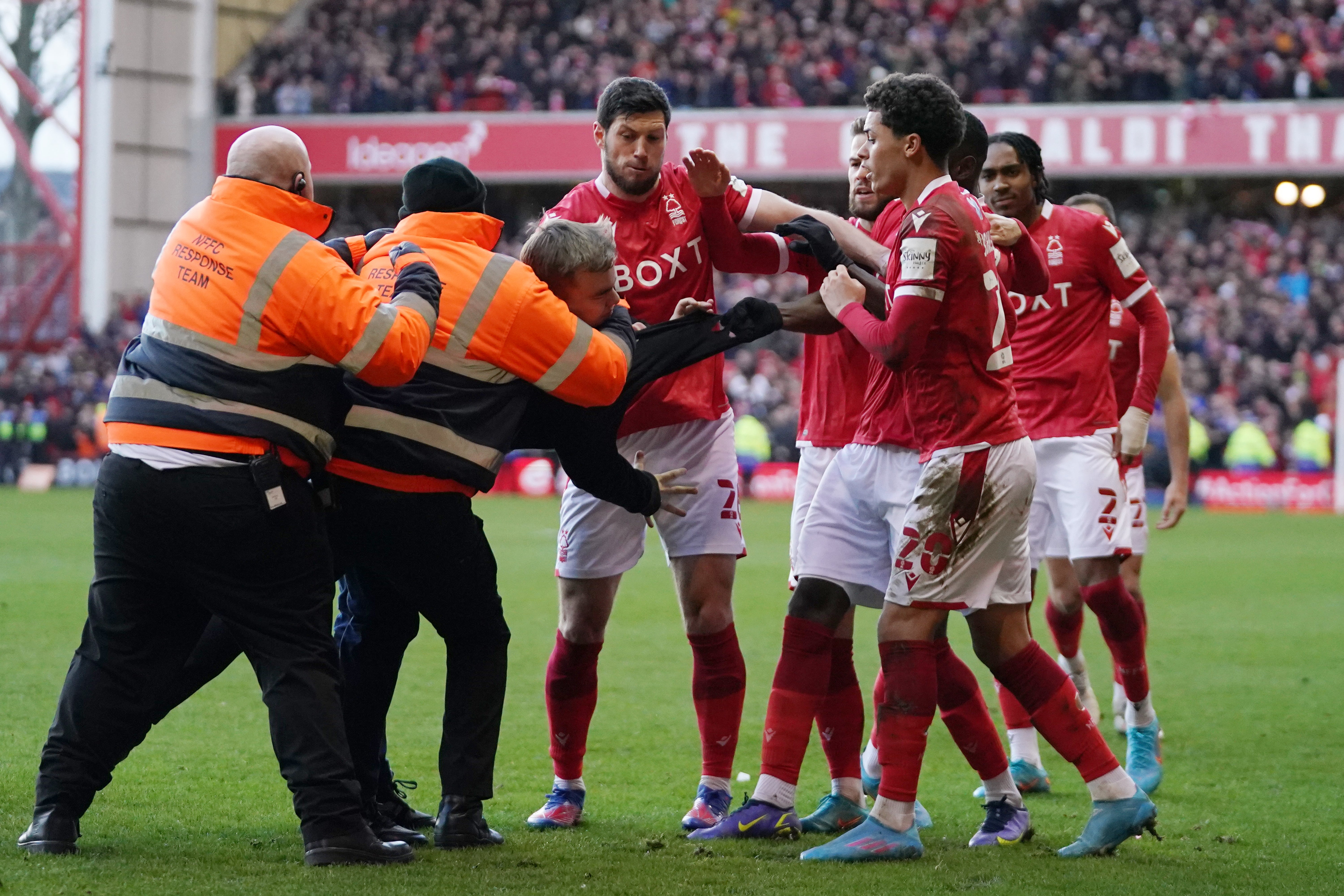 Stewards try to restrain a Leicester fan as he assaults Nottingham Forest players in an FA Cup tie earlier this season (Tim Goode/PA)