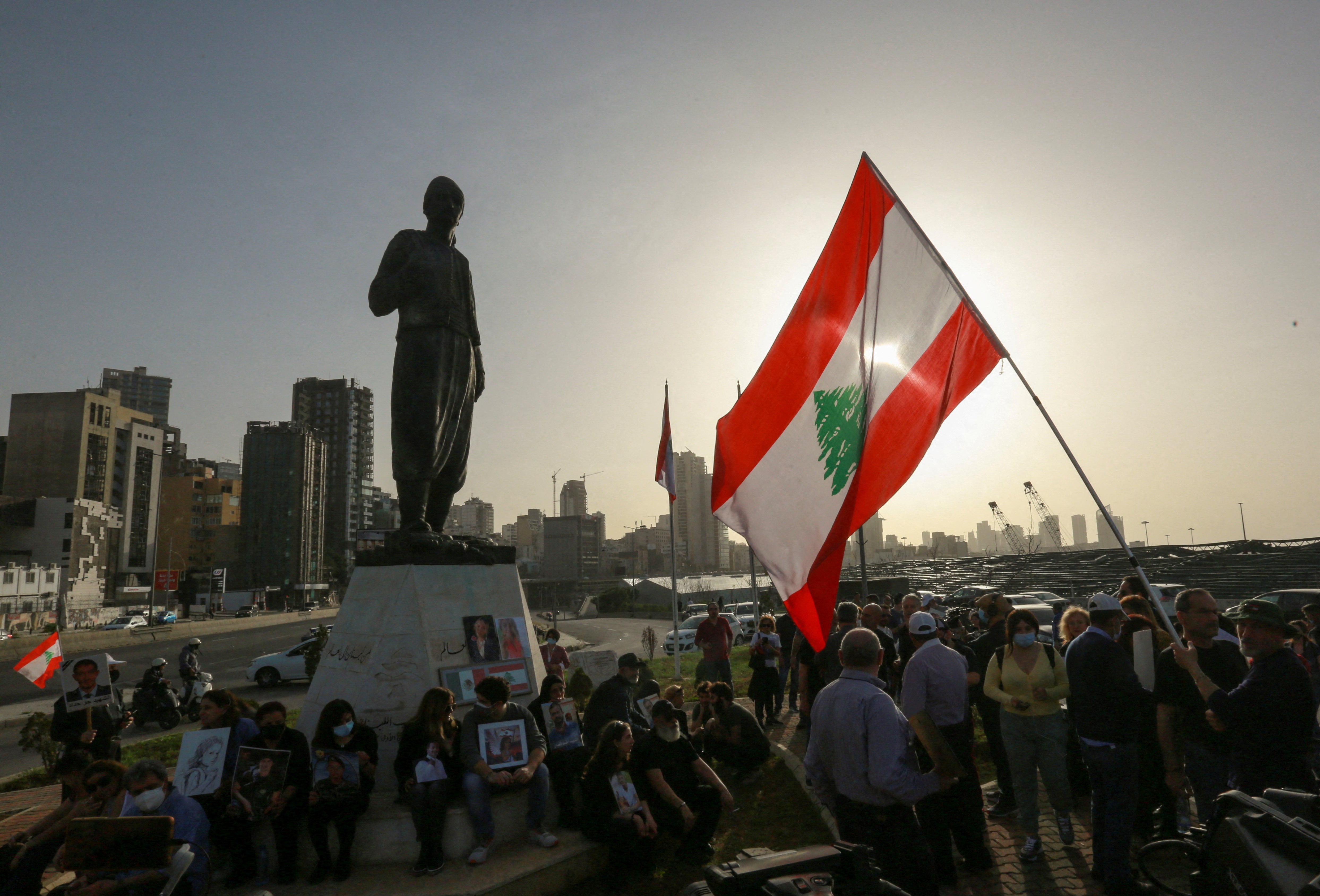 Families of the victims of the 2020 Beirut port explosion hold pictures during a protest in the city