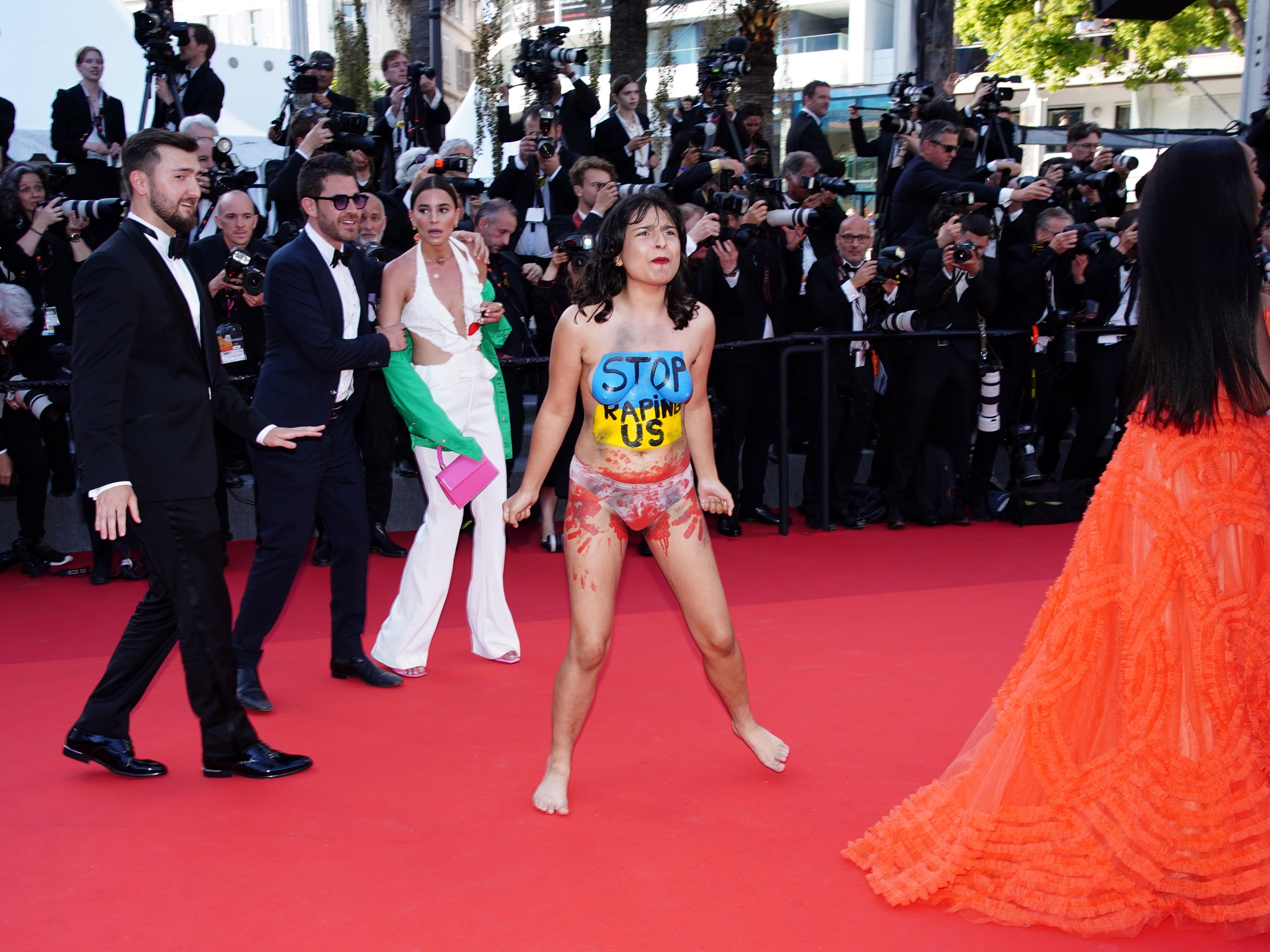 Ukraine protestor removed from Cannes by security after stripping on the red carpet The Independent image