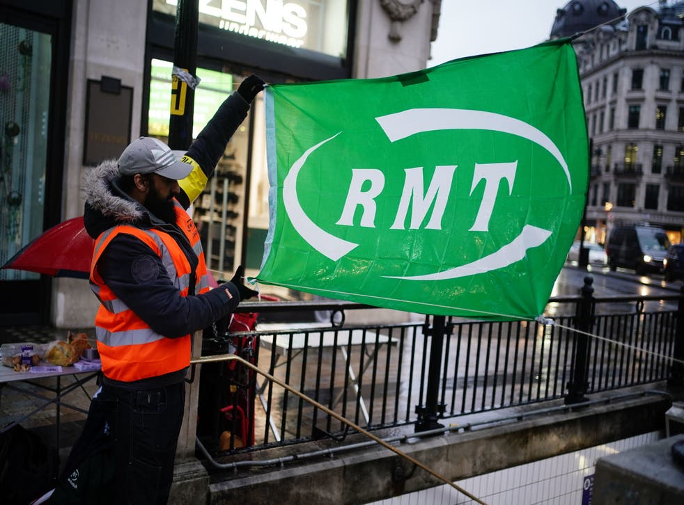 <p>Members of the RMT trade union on a picket line in central London in March</p>