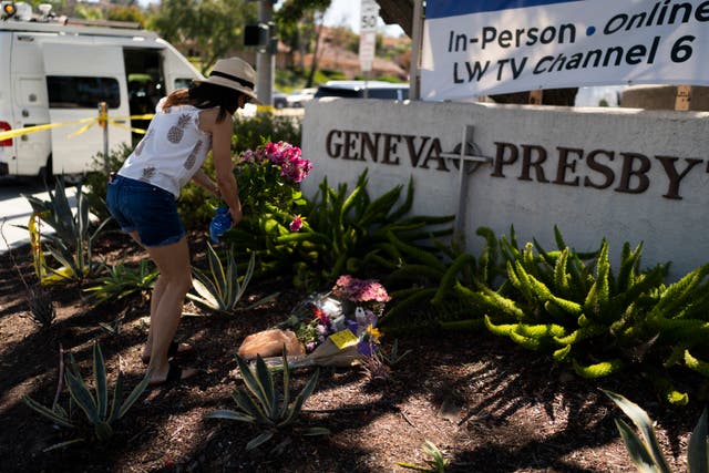 <p>File photo: Joanna Garcia, 47, leaves flowers outside Geneva Presbyterian Church to honor victims of shooting at the church on 15 May</p>
